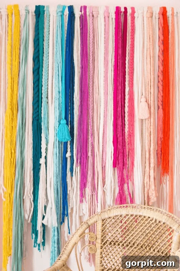 textured yarn wall hanging in rainbow colors