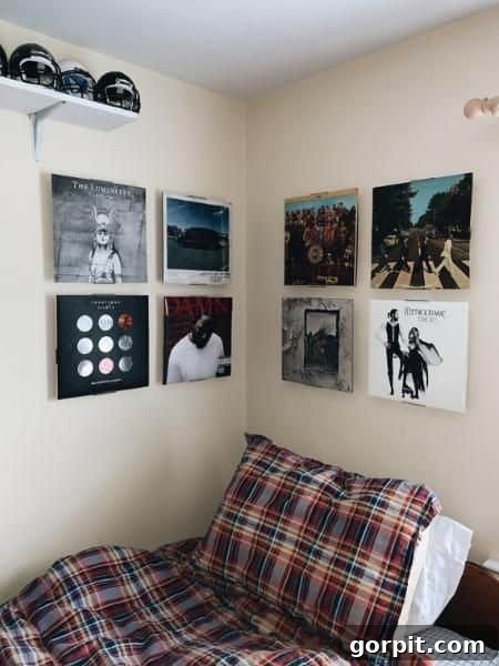 The Modern Guy's Dorm Room Playbook 11 A stylish dorm room featuring a collection of framed album covers displayed as unique wall art, adding personality and a musical touch.