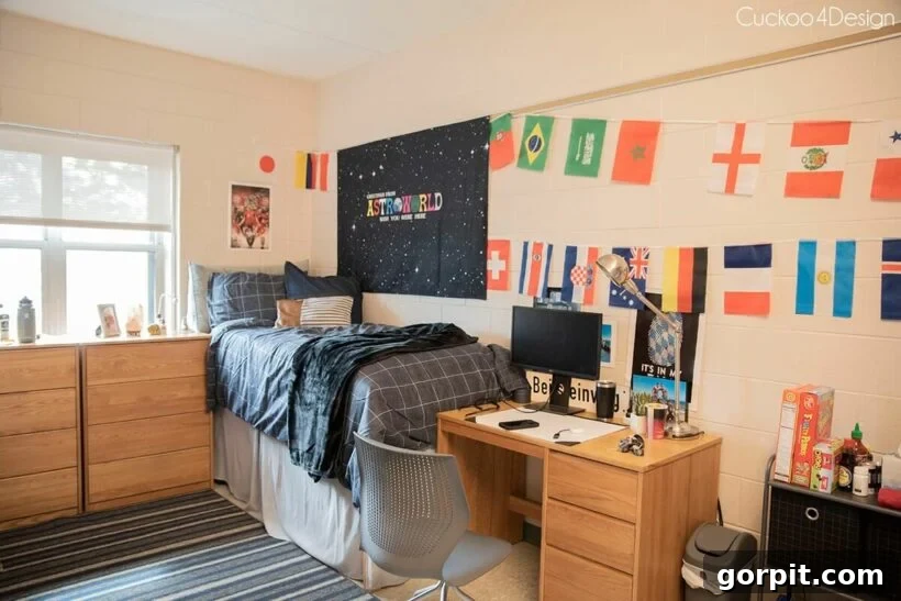 The Modern Guy's Dorm Room Playbook 15 A comfortable and well-lit study corner in a boy's dorm room, featuring international flags on the wall and gray bedding, creating a personalized and functional space.