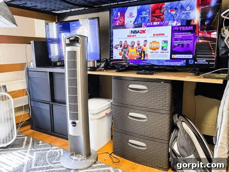 The Modern Guy's Dorm Room Playbook 16 A well-arranged dorm room featuring a dedicated video game setup with comfortable seating, dual monitors, and neatly organized gaming accessories.