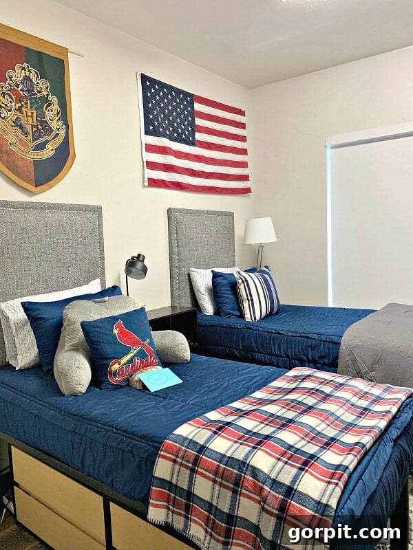 The Modern Guy's Dorm Room Playbook 3 A boy's dorm room featuring gray upholstered headboards and crisp blue bedding, creating a modern and comfortable sleeping area.