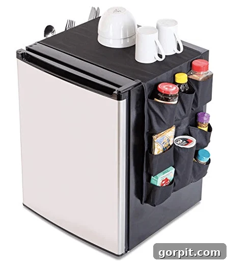 The Modern Guy's Dorm Room Playbook 7 Mini fridge with a fabric organizer featuring multiple pockets for snacks and drinks, maximizing storage efficiently.