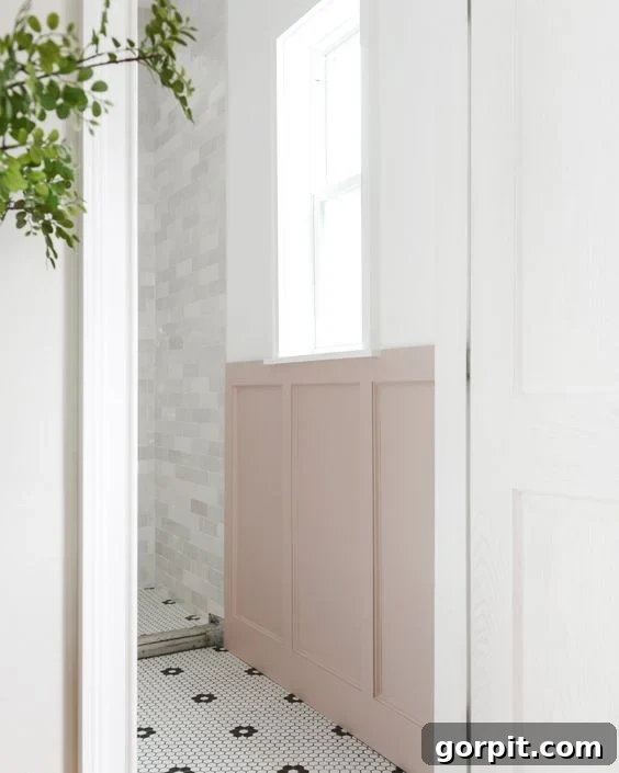 Affordable Bathroom Transformations: Smart DIY Renovation Ideas 11 Pink board and batten wall in a stylish black and white bathroom, adding character and a pop of color.