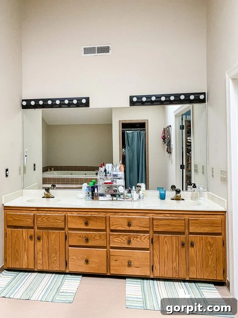 Affordable Bathroom Transformations: Smart DIY Renovation Ideas 12 Outdated 1980s master bathroom before a budget-friendly DIY remodel, showing dark and uninspired decor.
