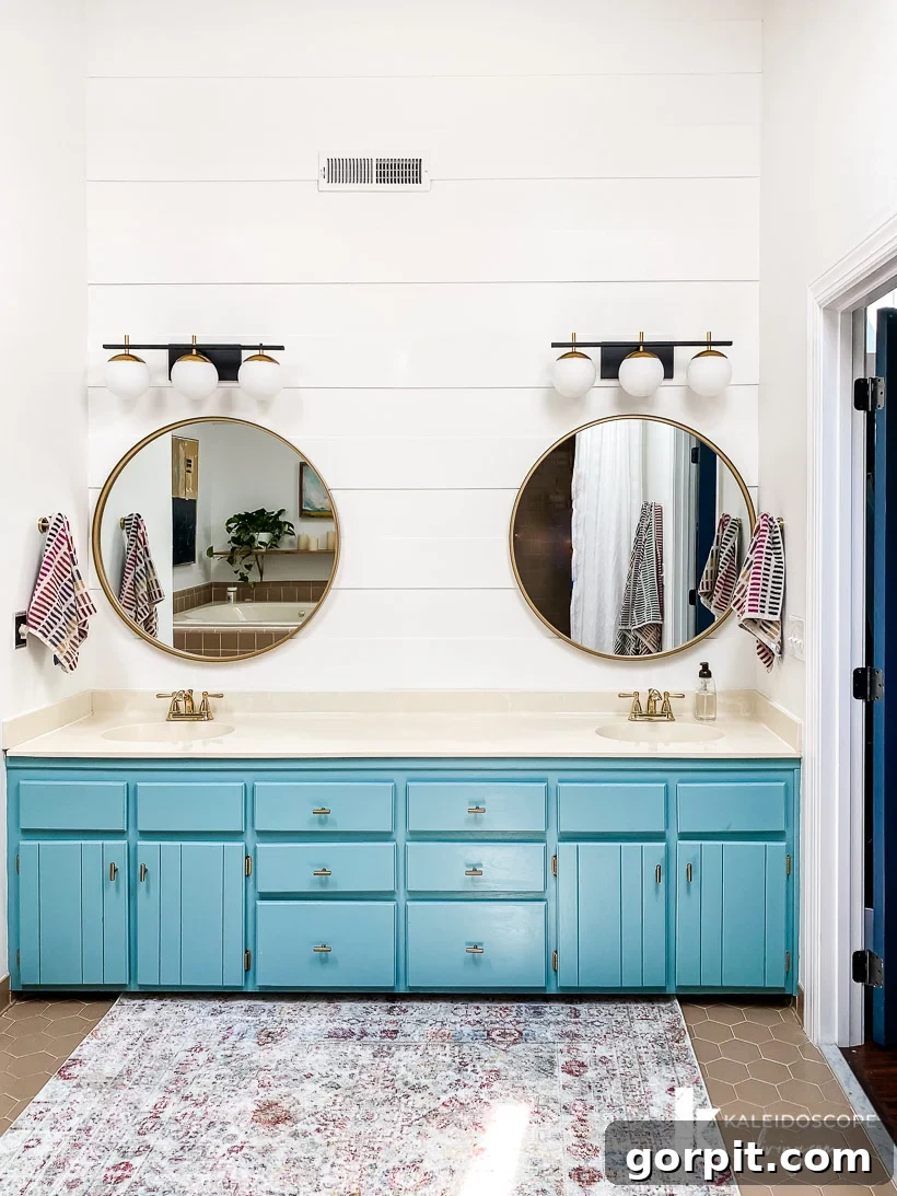 Affordable Bathroom Transformations: Smart DIY Renovation Ideas 13 Master bathroom transformed with a blue vanity and modern plank wall, creating a refreshed and updated atmosphere.