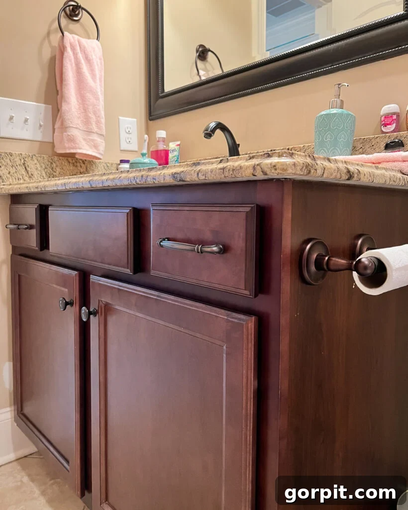 Affordable Bathroom Transformations: Smart DIY Renovation Ideas 3 Outdated dark wood bathroom vanity before a DIY budget remodel.