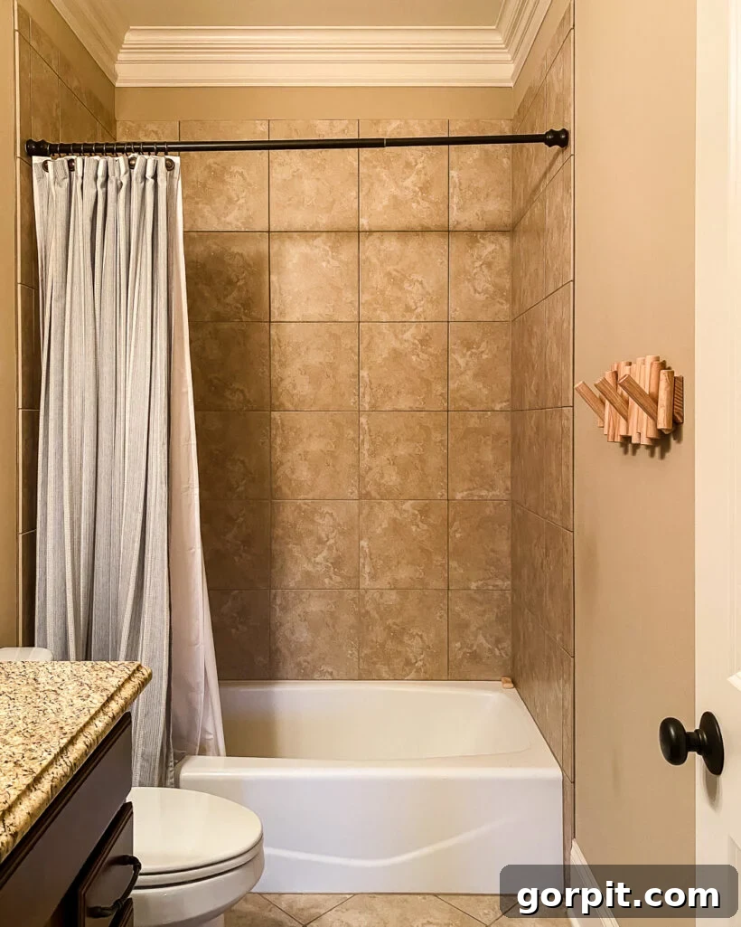 Affordable Bathroom Transformations: Smart DIY Renovation Ideas 20 Outdated bathroom with brown tile in the shower area, looking dull and uninspired.