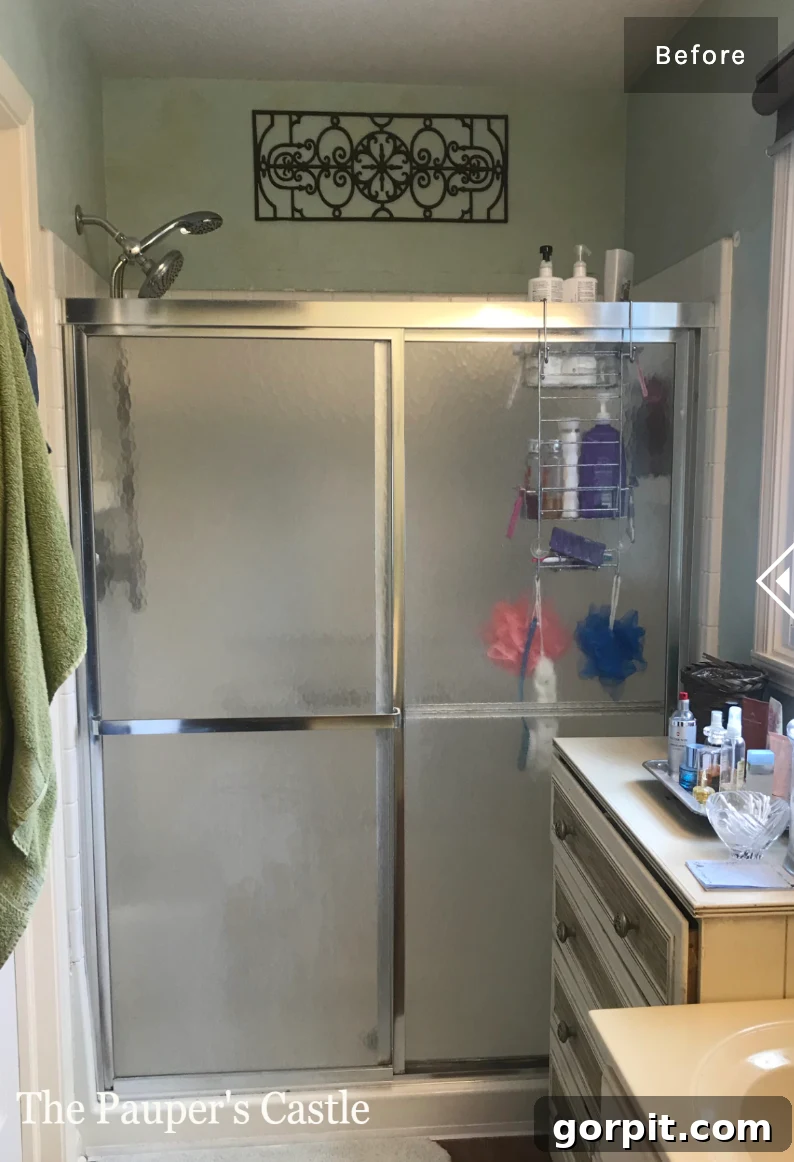 Affordable Bathroom Transformations: Smart DIY Renovation Ideas 22 Outdated sliding shower doors before a DIY paint transformation.