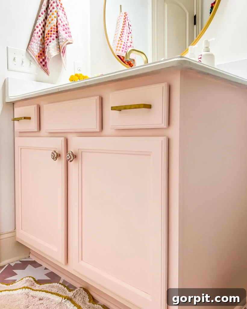 Affordable Bathroom Transformations: Smart DIY Renovation Ideas 4 Outdated vanity updated with pink paint and new hardware in a girl's bathroom, showcasing a fresh, modern look.