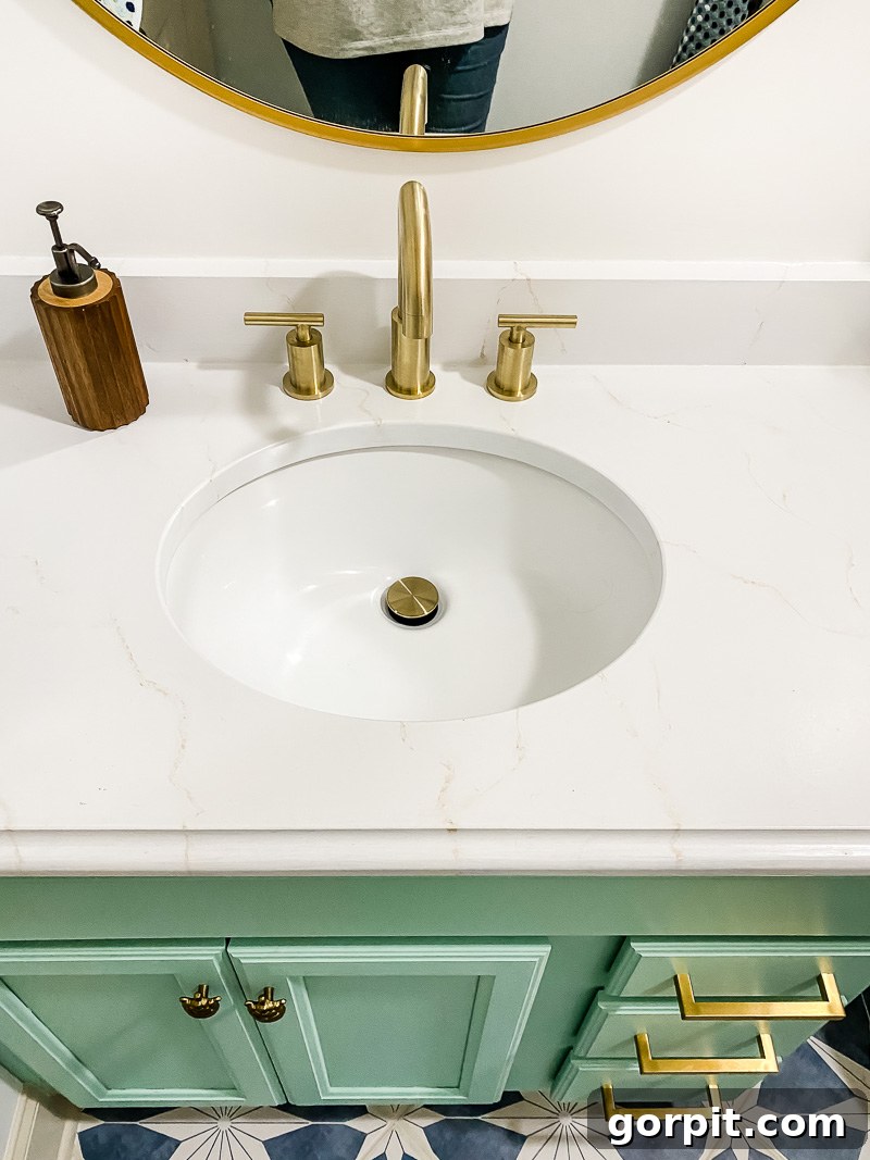 Affordable Bathroom Transformations: Smart DIY Renovation Ideas 6 Updated vanity with countertops painted to look like marble in a girl's bathroom, featuring a bright and modern aesthetic.