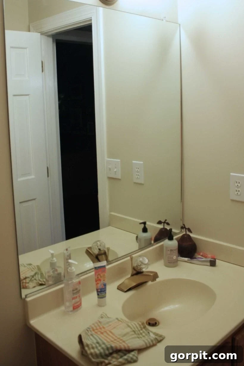 Affordable Bathroom Transformations: Smart DIY Renovation Ideas 7 Outdated cultured marble vanity in a bathroom before a concrete overlay renovation.