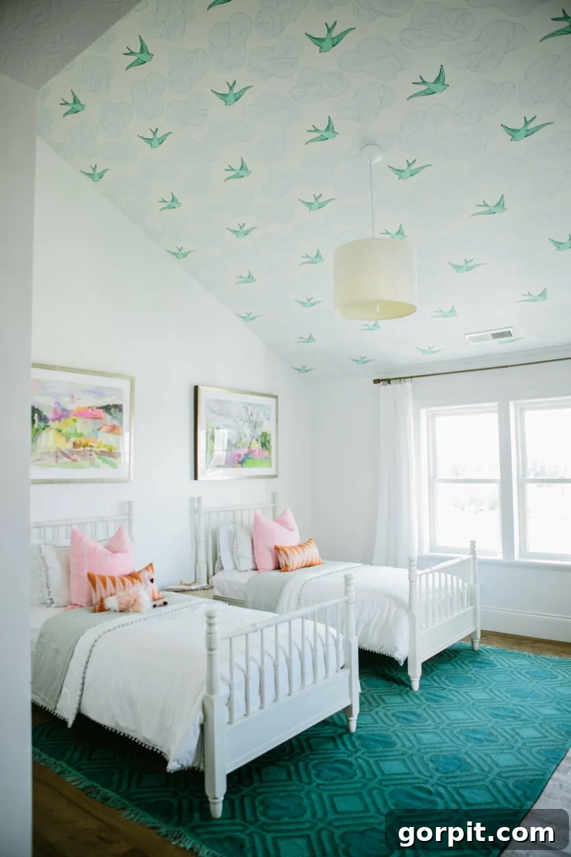 white girls' room with emerald green rug and wallpaper ceiling with clouds and birds