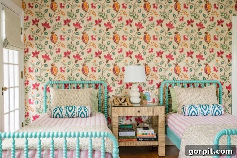 pink and orange floral print wallpaper with turquoise jenny lind beds and striped bedspreads