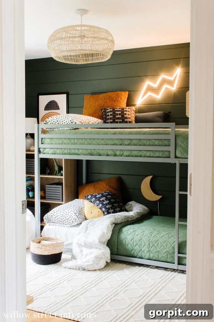 dark green walls and gray bunk bed with light green bedding