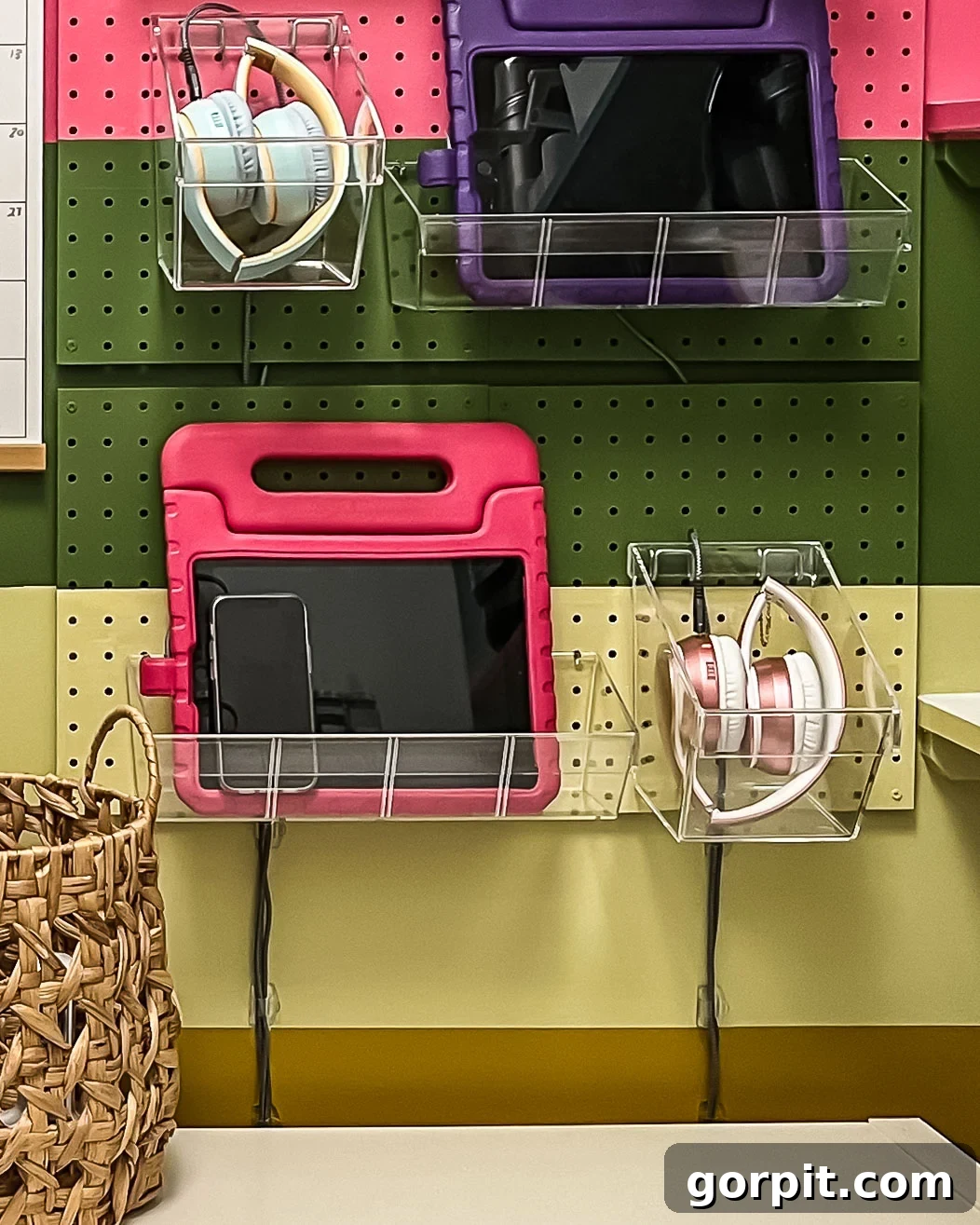Close-up of Command Cord Clips used to neatly secure visible power cords under the pegboard charging station