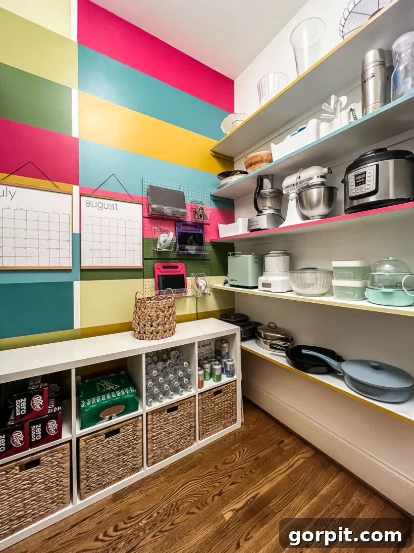 Colorful walk-in pantry after makeover showing organized shelves with cookware, small appliances, and serving dishes.