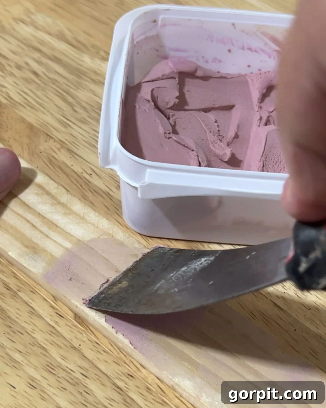 Smart Magnetic Poster Mounts 7 Applying DAP Plastic Wood-X wood filler to a lattice strip to smooth out imperfections before sanding, showing the pink application stage.