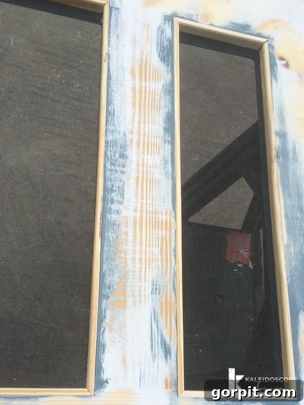 Installing screen molding to cover staples and finish the screen door's back side.