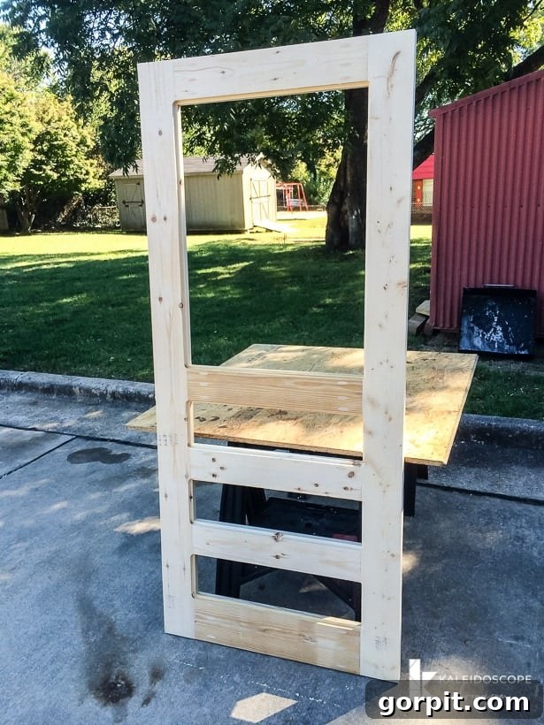 The fully assembled wooden frame of the DIY screen door, ready for finishing.