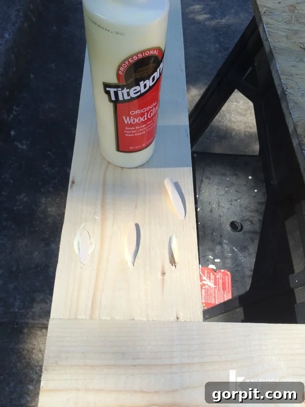 Close-up of filled pocket holes and sanded wood on the DIY screen door frame.