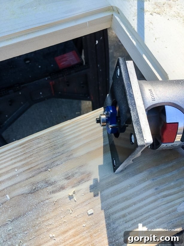Router in action, creating a rabbet joint for screen installation on the DIY screen door.