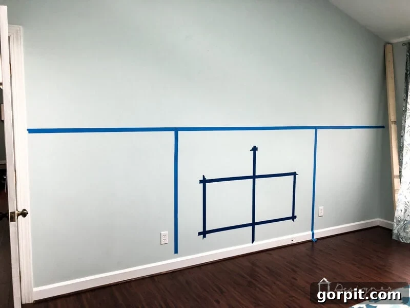 Taping out the planned electric fireplace layout on the wall