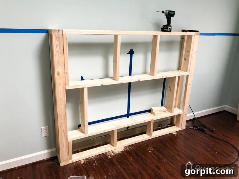 Wood frame construction for the DIY electric fireplace, with baseboard removed