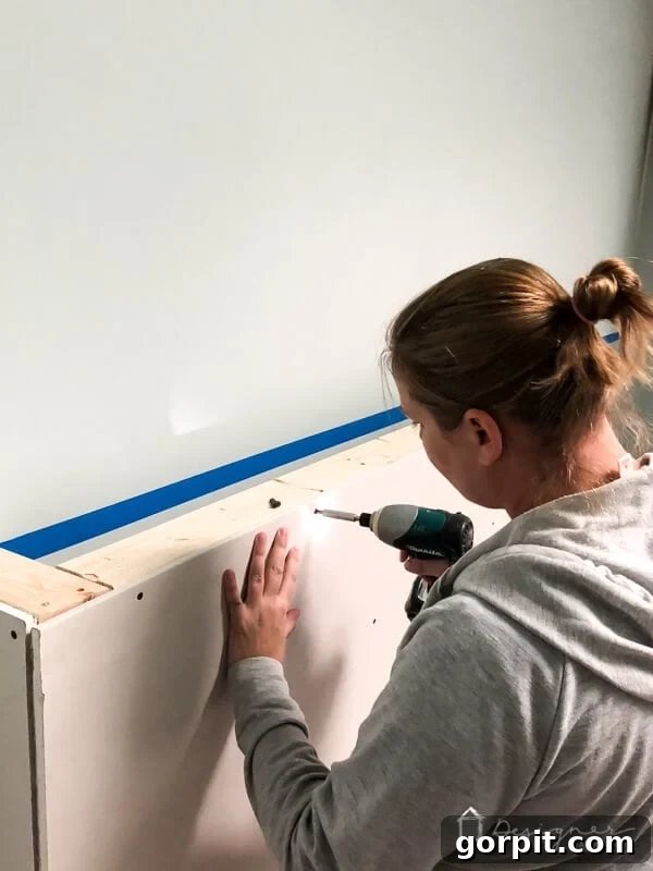 Drywall enclosure around the installed wood frame for the electric fireplace