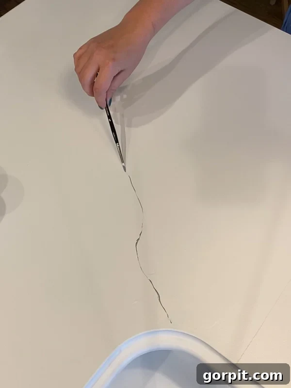 Painted Countertops The Long Haul Report 3 Woman painting grey veins on countertops to look like marble