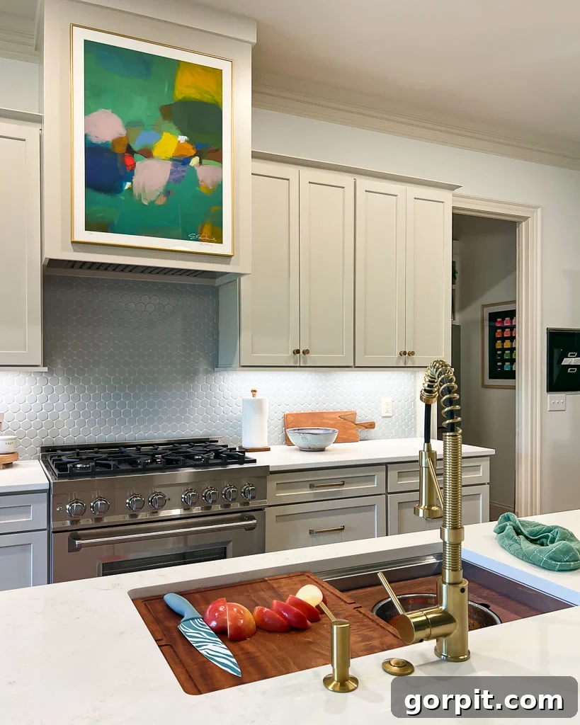 Our Kitchen Renovation Reveal A Perfect Blend of Neutral and Color 13 A pristine workstation sink integrated into a modern kitchen, highlighting its practical design and elegant appeal.