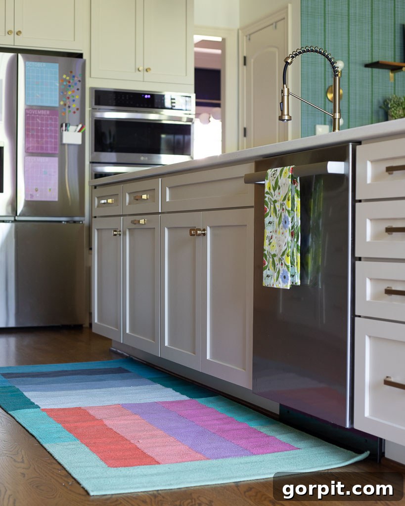 Our Kitchen Renovation Reveal A Perfect Blend of Neutral and Color 15 A vibrant kitchen rug runner in front of the sink, adding a pop of color to the neutral floor.
