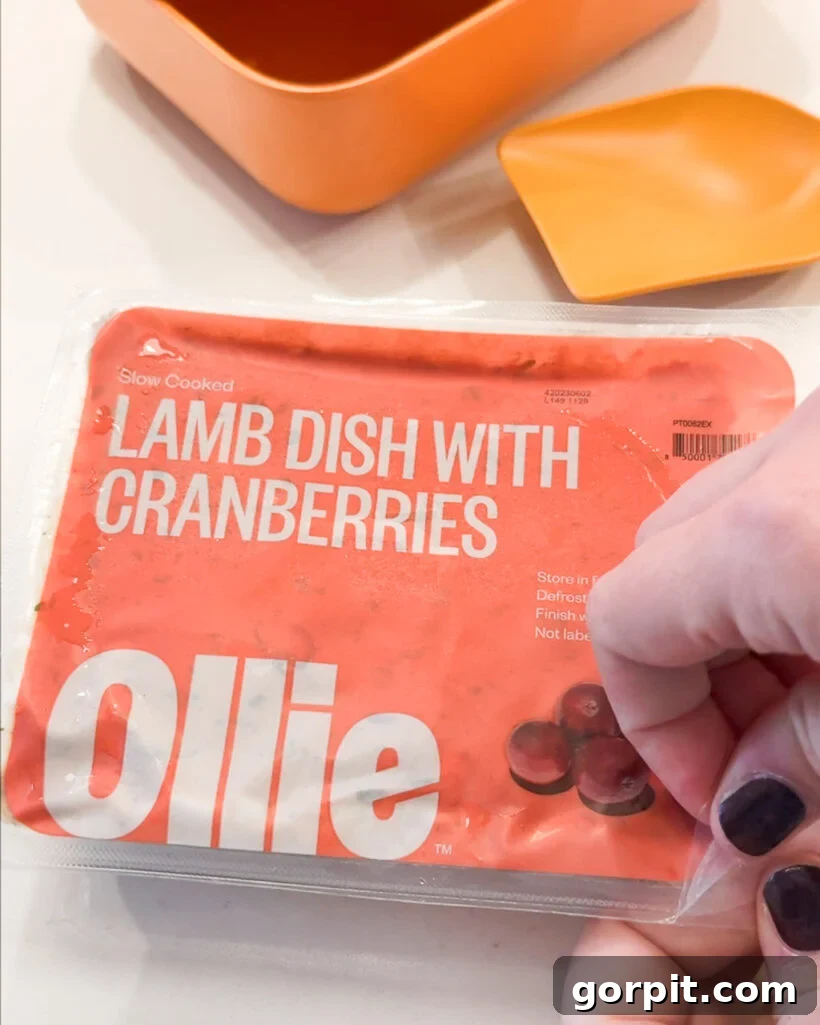 woman's hands opening package of Ollie fresh dog food