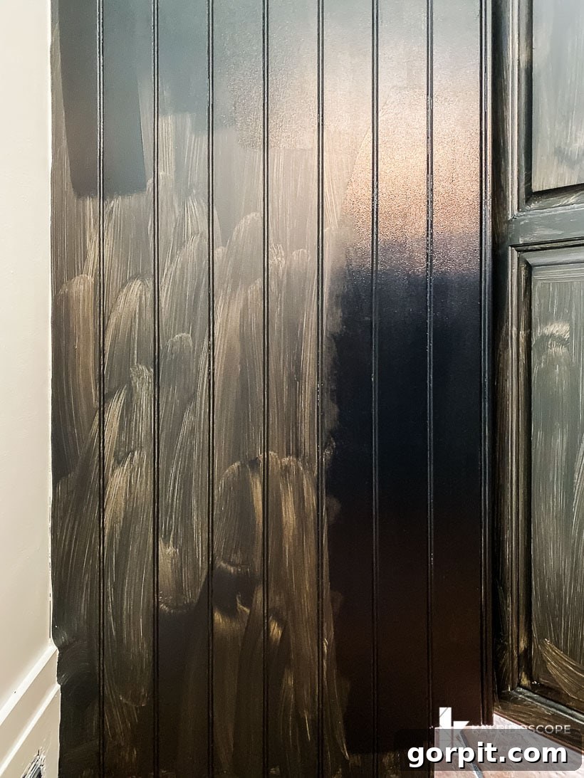 Kitchen Cabinet Painting My Three-Time DIYers Proven Process 13 image of beadboard kitchen cabinetry partially painted with black paint from Fusion Mineral Paint--one side shows coverage from single coat, the other side shows corage with a second coat of paint