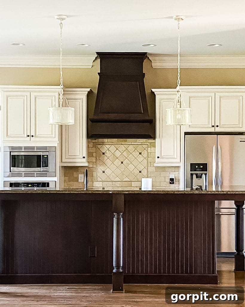 Kitchen Cabinet Painting My Three-Time DIYers Proven Process 15 outdated kitchen with dark brown island and range hood and cream colored kitchen cabinets before being painted