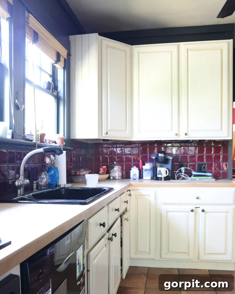 Kitchen Cabinet Painting My Three-Time DIYers Proven Process 4 photo of outdated kitchen with red tile backsplash, black walls and damaged cream colored cabinets