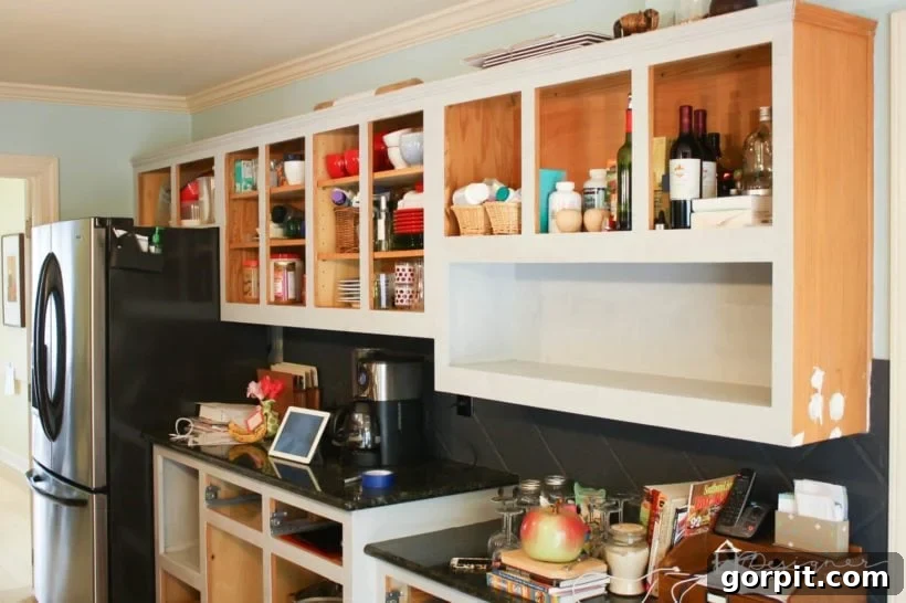Will Your DIY Cabinet Paint Job Survive the Kitchen 3 photo of oak kitchen cabinets in the process of being painted a light gray color
