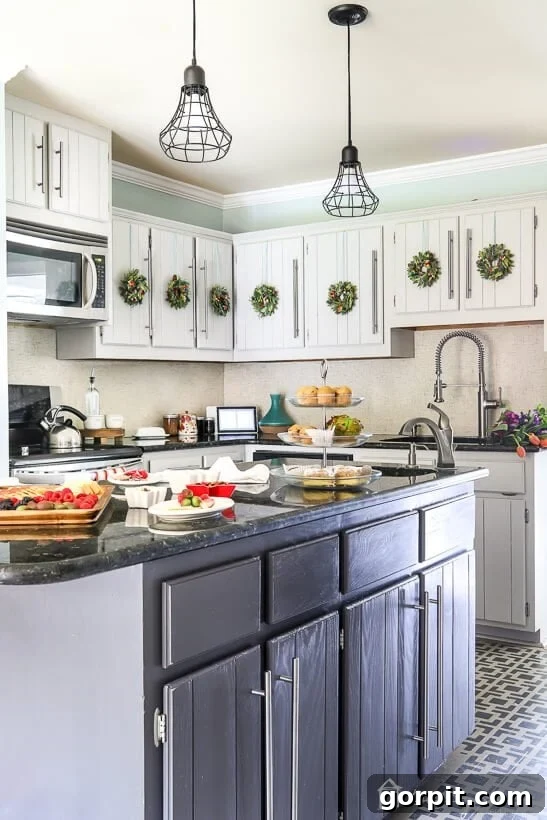 Will Your DIY Cabinet Paint Job Survive the Kitchen 4 photo of kitchen with light and dark gray cabinets decorated for Christmas with mini Christmas wreaths on the kitchen cabinet doors
