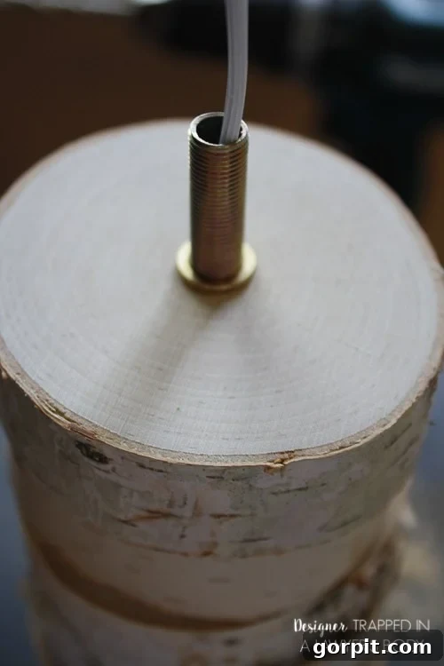 Installing the Threaded Nipple into the Topmost Wood Slice of the Lamp Base