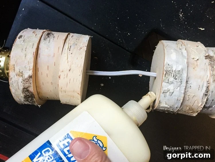 Applying Wood Glue to Stacked Wood Slices for a Secure Lamp Base