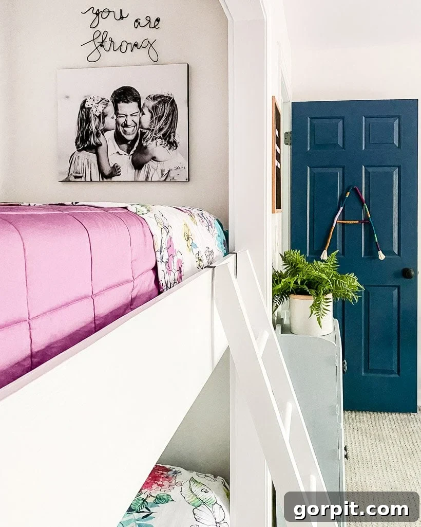 Colorful bunk beds with a DIY photo canvas hanging on the wall