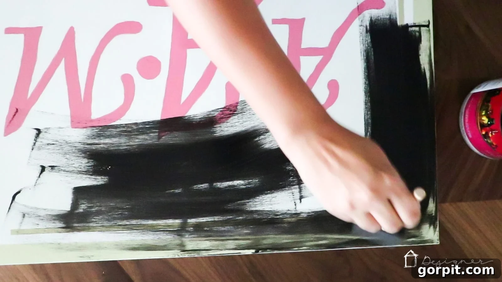 Painting the sides of a blank canvas with black acrylic paint