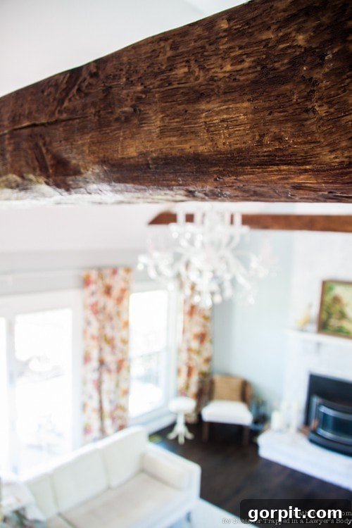 Faux Wood Beams Your Ceiling Masterpiece 12 Finished faux wood beam installed on a vaulted ceiling, showcasing its realistic wood grain texture and seamless integration.