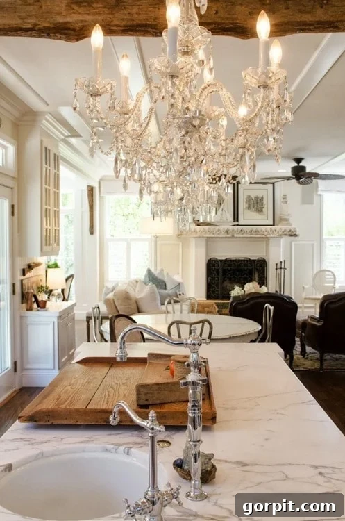 Faux Wood Beams Your Ceiling Masterpiece 5 Luxurious kitchen featuring dark faux wood beams contrasting with a sparkling glam chandelier, from The Kitchn.