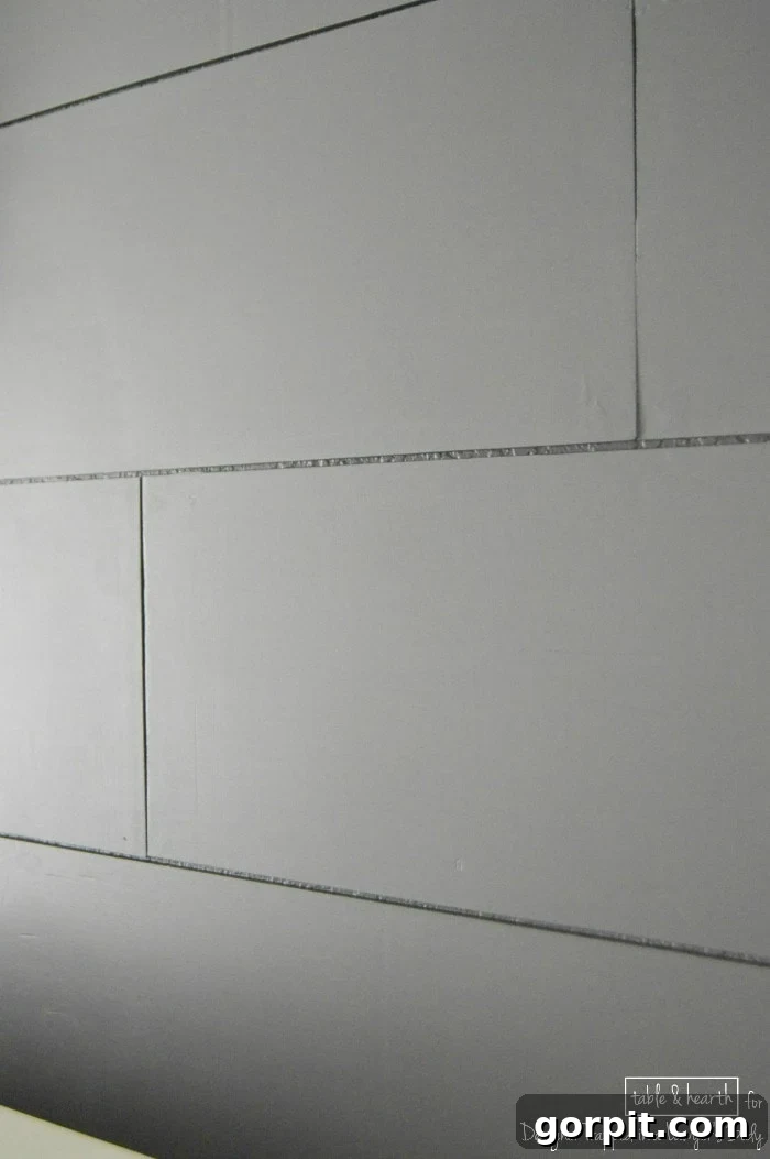 Close-up detail of a finished DIY wood plank wall, showcasing the textured surface and paint