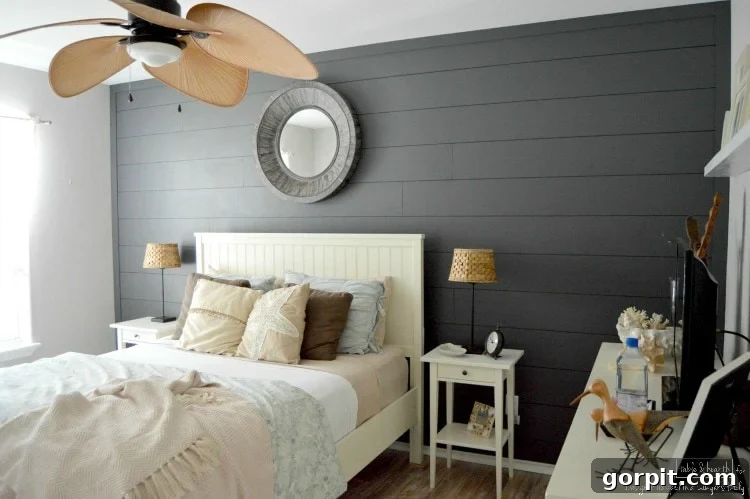 Cozy guest room with a newly installed DIY plank wall and comfortable bed