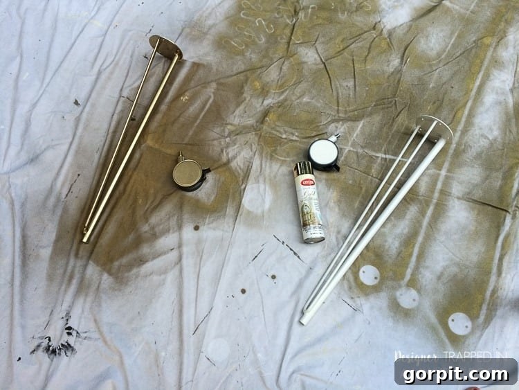 Spray painting Krille legs gold for a custom IKEA desk hack, showcasing the transformation of the base components.