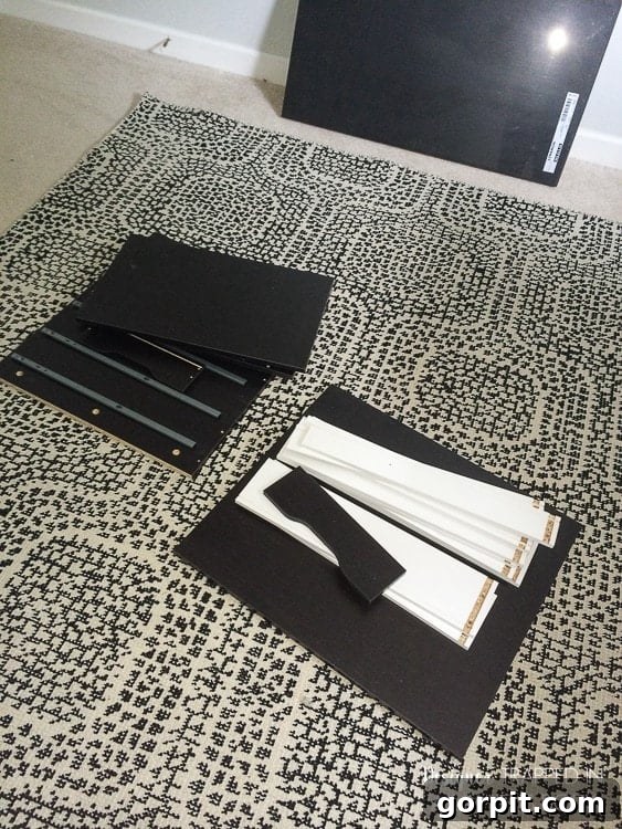 Assembling the IKEA Alex drawer unit, a practical storage solution that forms a key component of this budget-friendly desk hack.