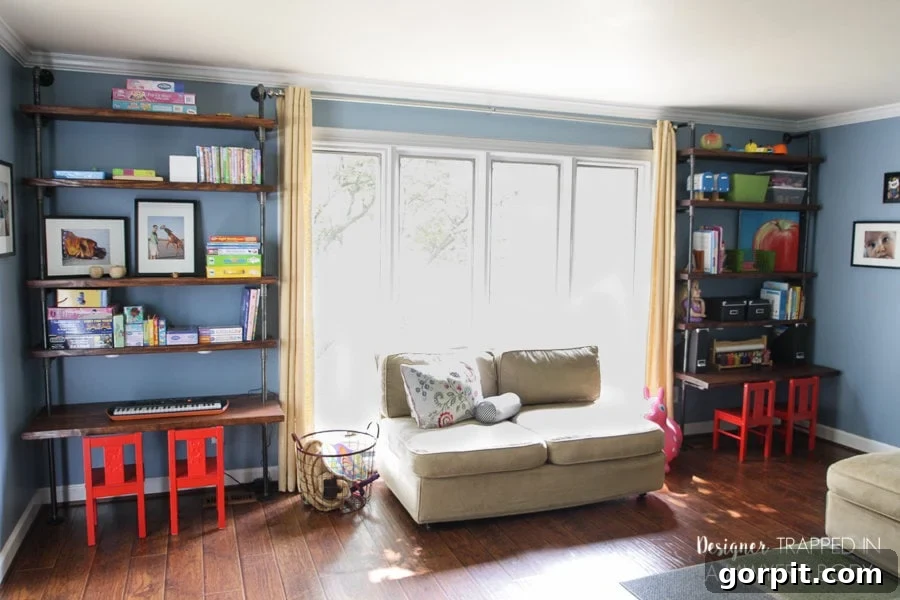 Finished DIY industrial pipe shelves and built-in desk in playroom