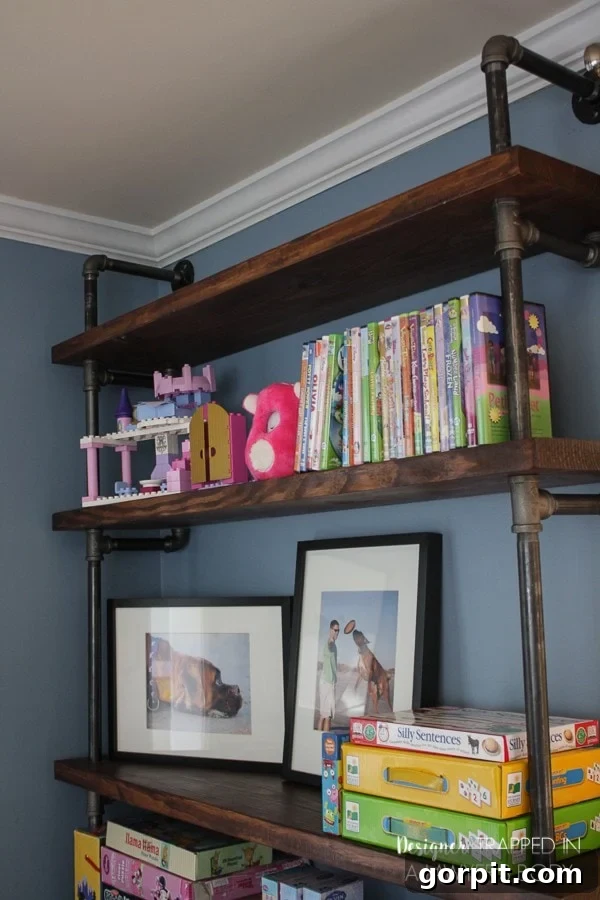 Close-up of organized DIY industrial pipe shelves with decor