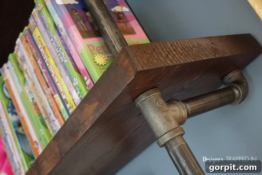 Custom built-in desk integrated with pipe shelving
